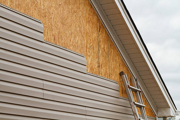 Professional Storm Damage Siding Repair technician working in Bremen, OH